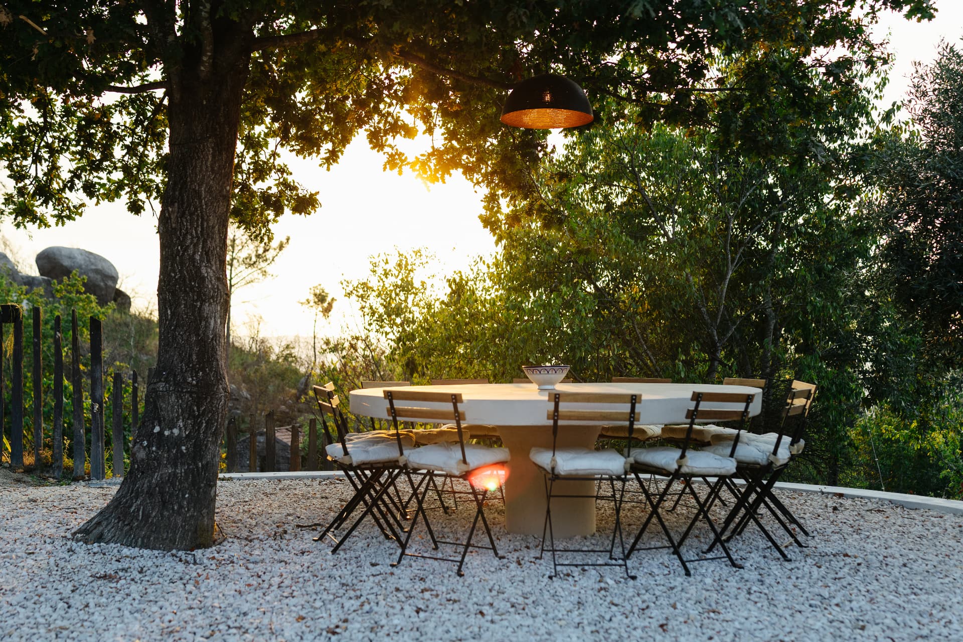 Outdoor dining table under the trees at sunset